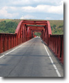Some old bridge over river in the country side with open view on a church.